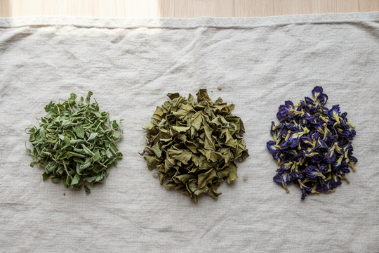 Dried mamaki mint and butterfly pea flower on linen