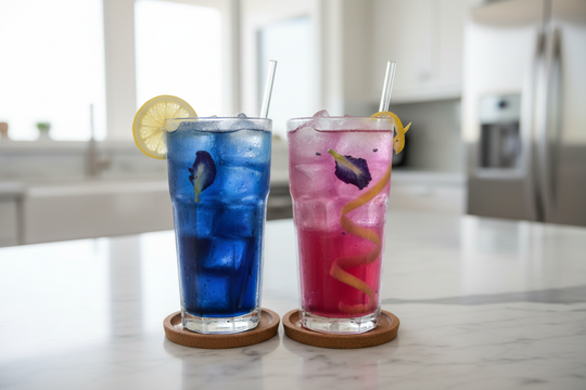 Two glasses of butterfly pea flower iced tea side by side - blue on the left and pink-purple on the right showing the color change effect